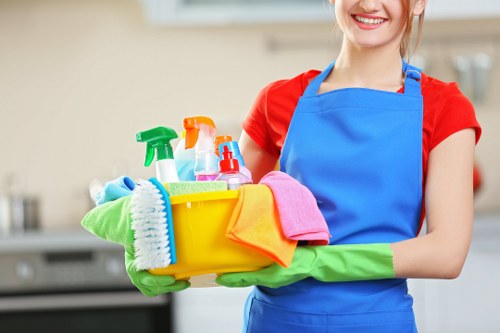 Cleaner applying safe working practices during a routine cleaning task