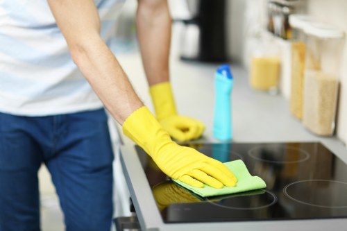 Technician treating a fabric armchair during upholstery cleaning